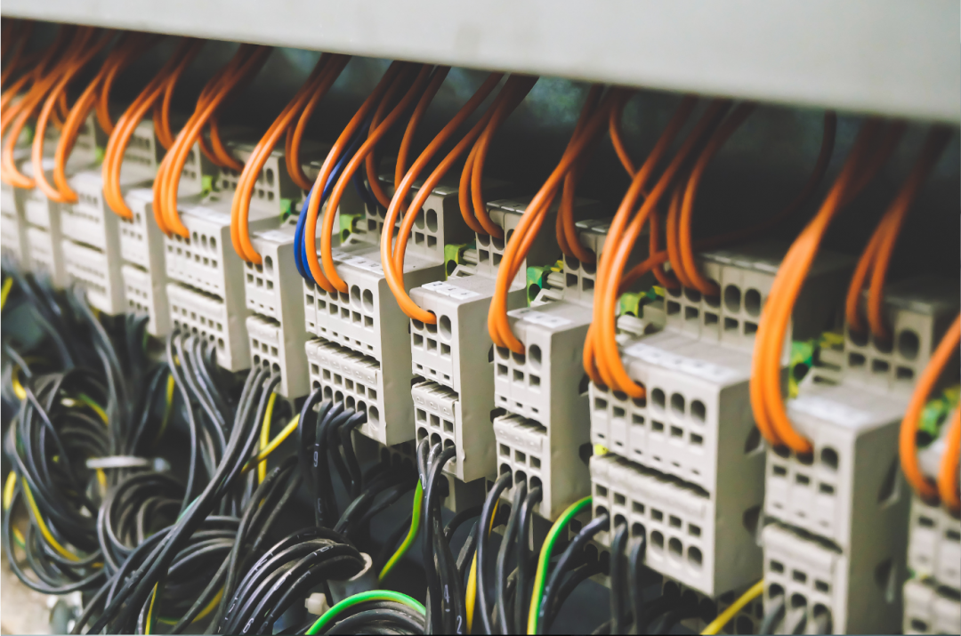 Rows of terminal blocks and color-coded wiring inside an industrial electrical control panel